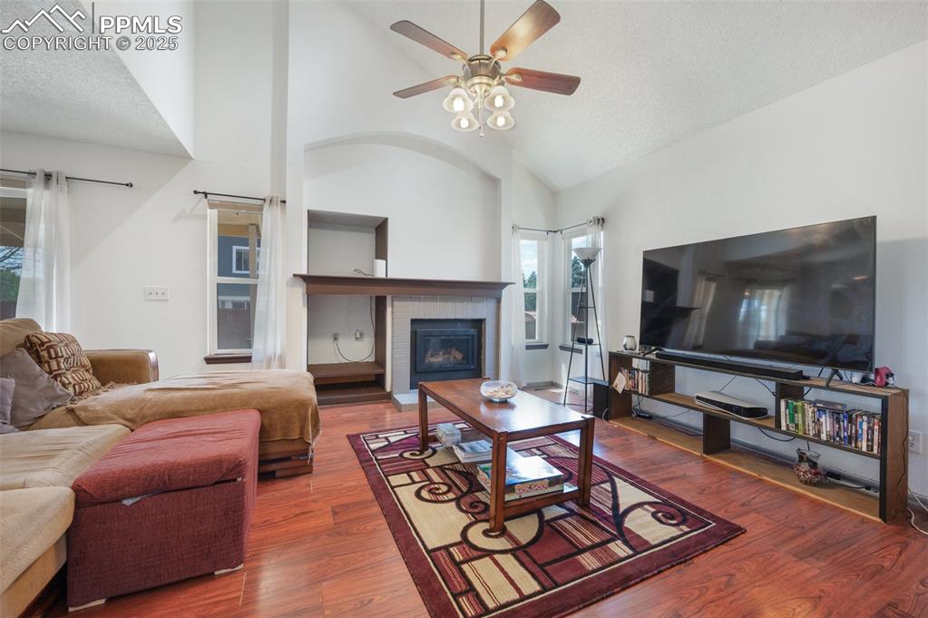 Image 10 of 50: Living area with healthy amount of natural light, a ceiling fan, wood finis