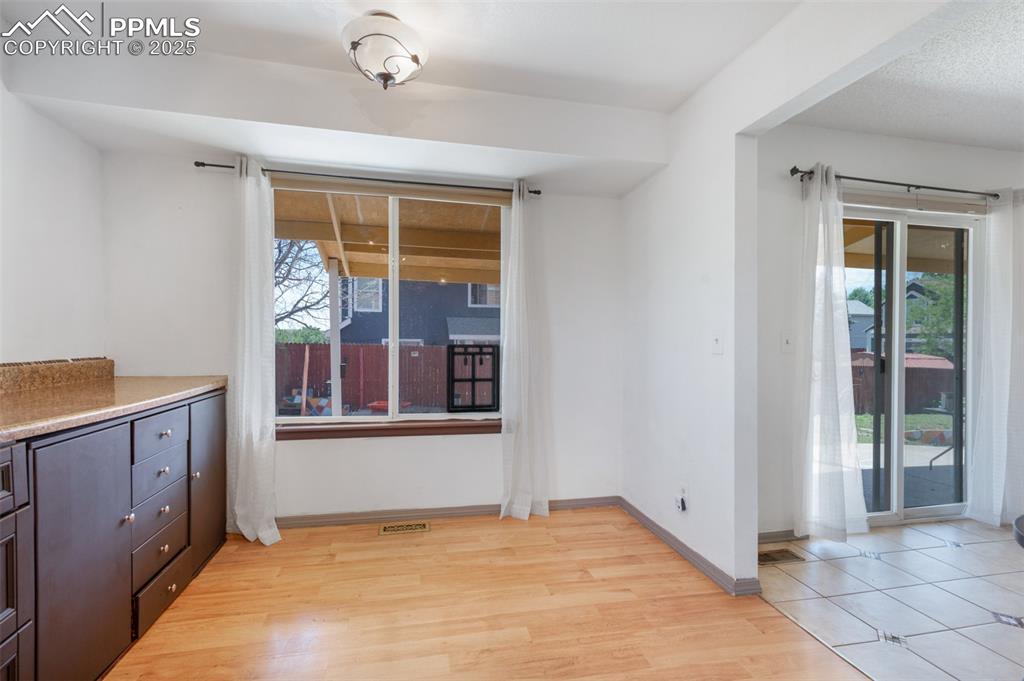 Image 24 of 50: Unfurnished dining area featuring plenty of natural light and light wood-ty