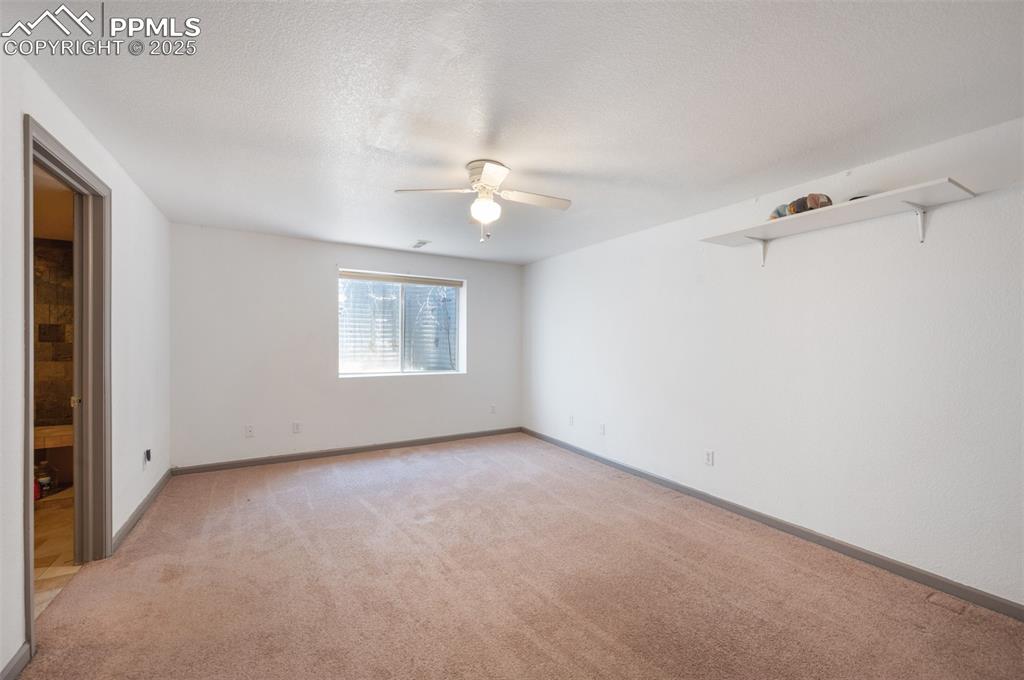 Image 34 of 50: Spare room with light colored carpet and a ceiling fan