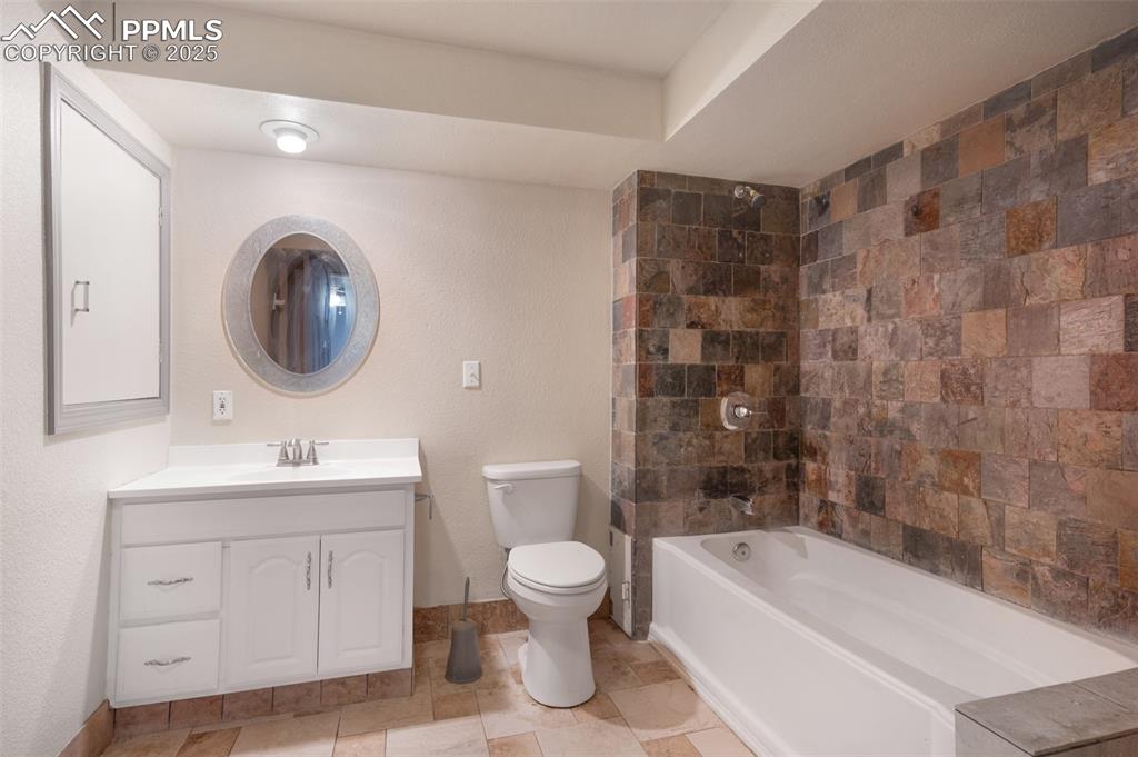 Image 37 of 50: Bathroom featuring vanity and tub / shower combination