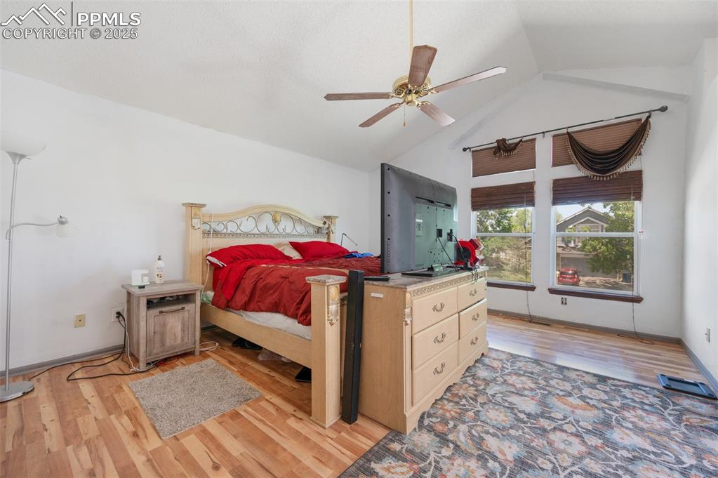 Image 38 of 50: Bedroom featuring light wood-type flooring, high vaulted ceiling, and ceili