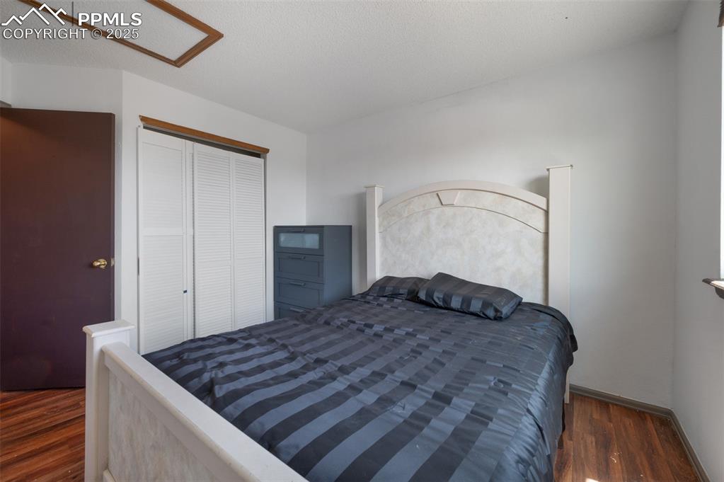Image 47 of 50: Bedroom with wood finished floors and a closet