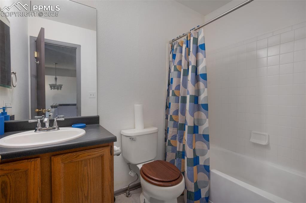 Image 48 of 50: Bathroom with shower / bath combination with curtain and vanity