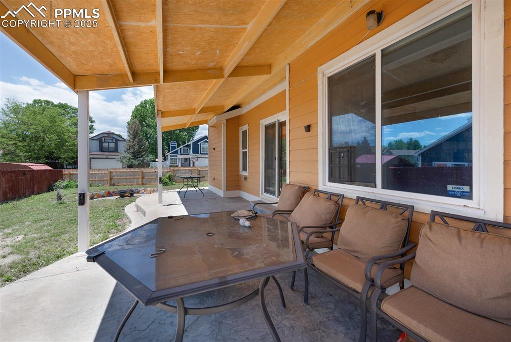 Image 50 of 50: Fenced backyard with a patio area