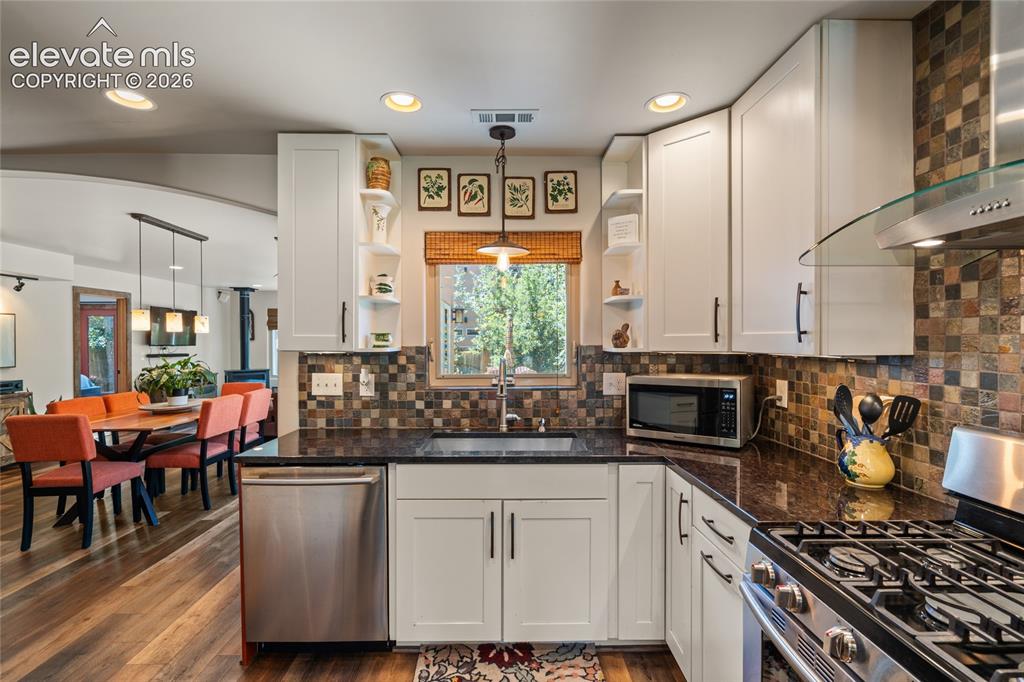 Image 10 of 38: Main house Kitchen view towards Dining Area