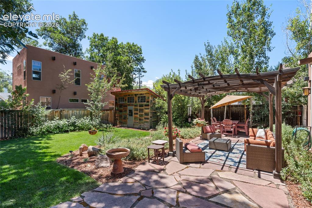 Image 2 of 38: Gorgeous backyard patio space complete with pergola.