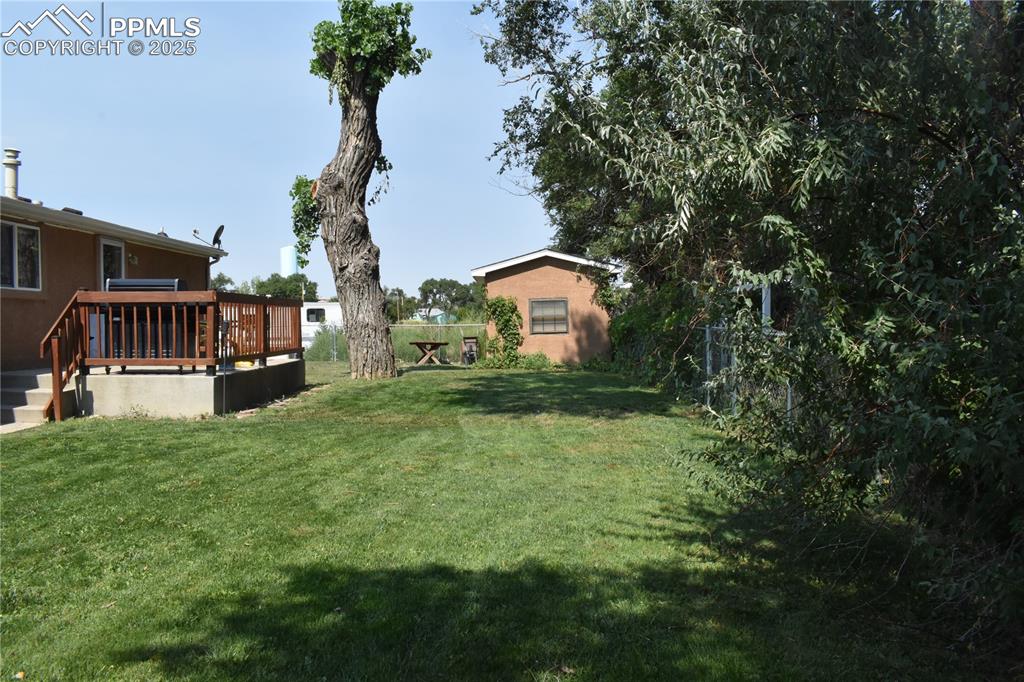 Image 10 of 47: View of yard with a wooden deck