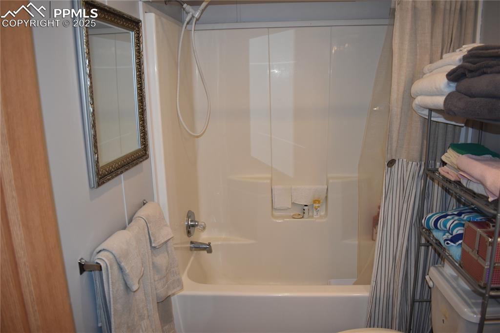 Image 32 of 47: Full bath featuring shower / bathtub combination with curtain