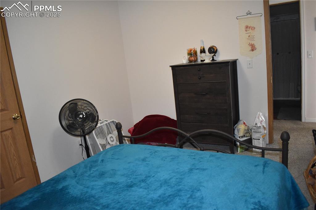 Image 34 of 47: Bedroom with carpet flooring