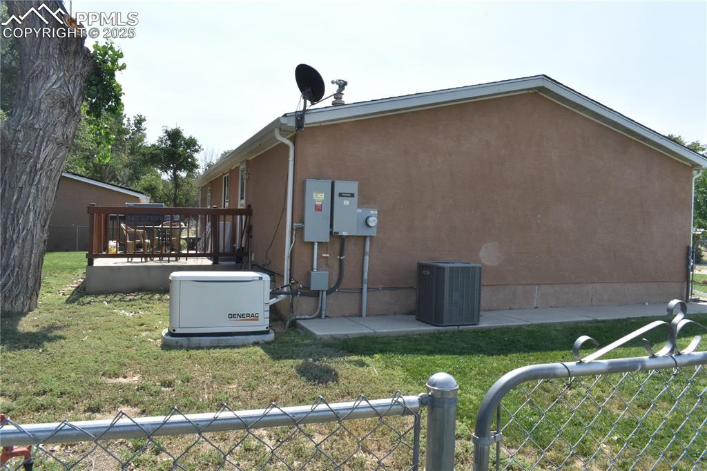 Image 4 of 47: View of property exterior featuring stucco siding and a deck