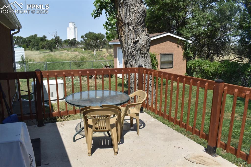 Image 44 of 47: View of patio / terrace featuring outdoor dining area and an outdoor struct
