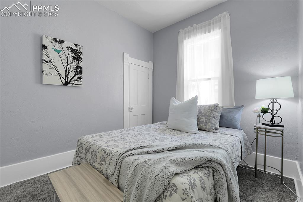 Image 15 of 29: Bedroom with carpet flooring and a textured wall