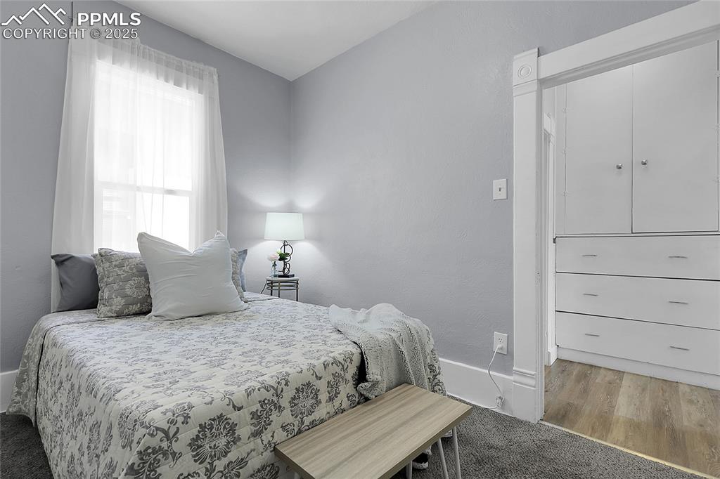 Image 16 of 29: Bedroom with baseboards and wood finished floors