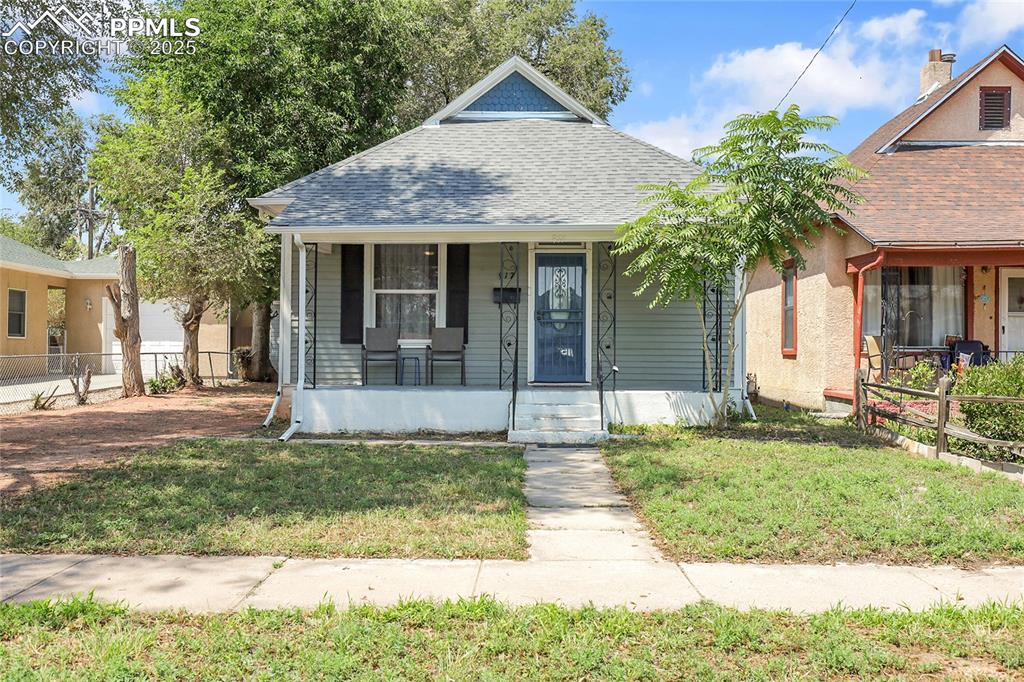 Image 2 of 29: Bungalow-style house featuring covered porch and roof with shingles