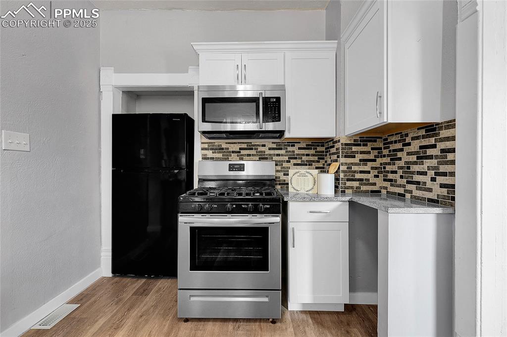 Image 20 of 29: Kitchen featuring appliances with stainless steel finishes, tasteful backsp