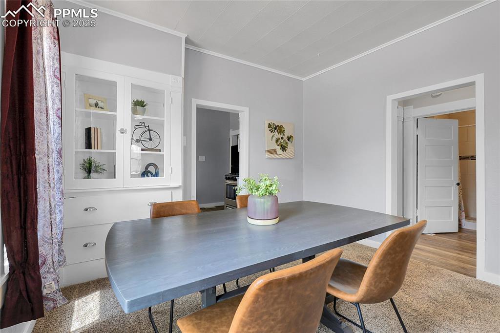 Image 9 of 29: Dining space featuring crown molding