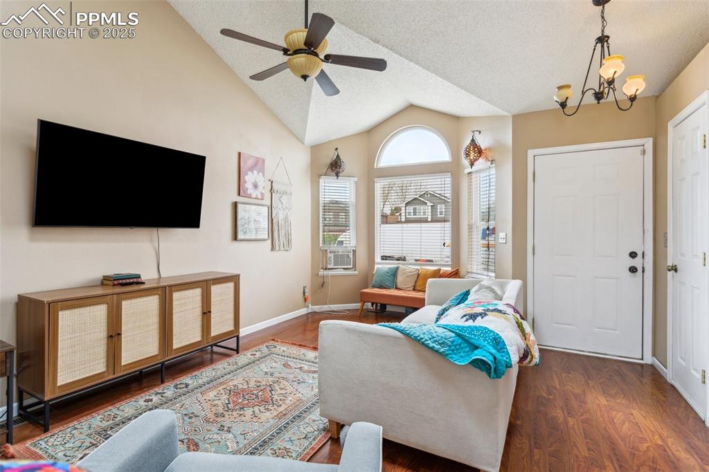 Image 10 of 35: Living room featuring a textured ceiling, wood finished floors, baseboards,