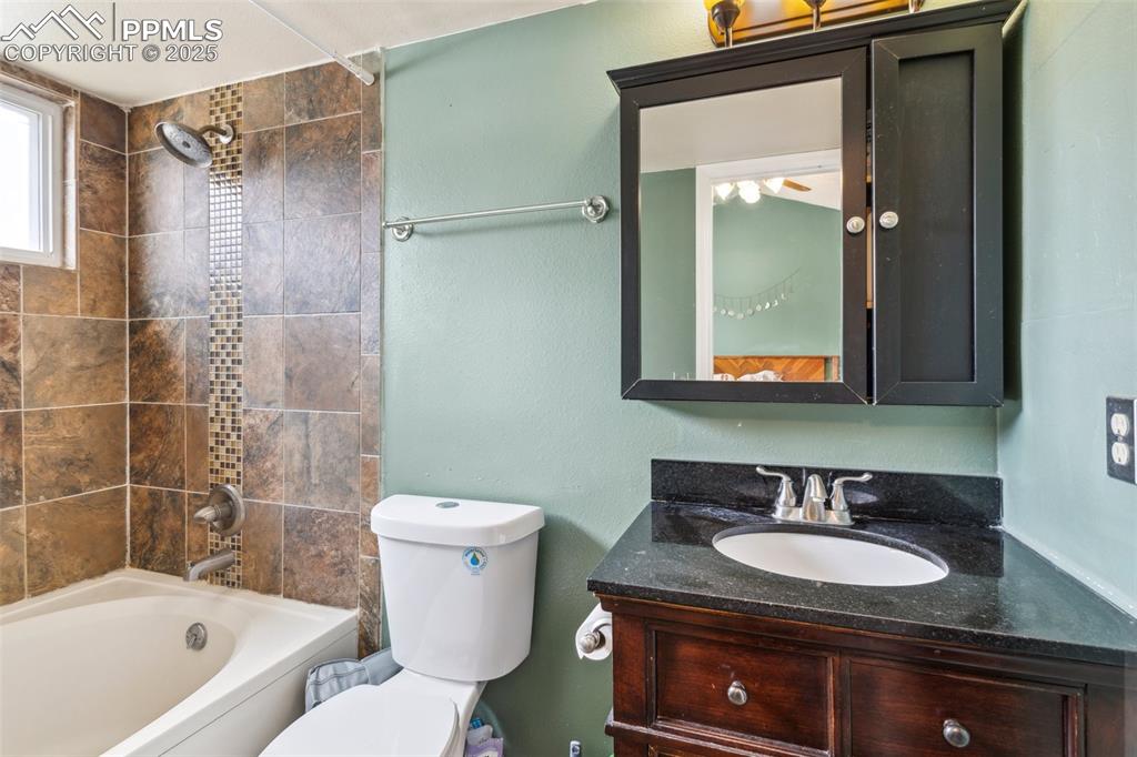Image 23 of 35: Full bath with vanity, bathtub / shower combination, and toilet