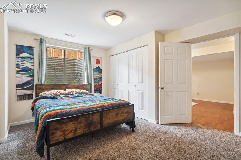 Image 25 of 35: Bedroom with carpet flooring, baseboards, visible vents, and a closet