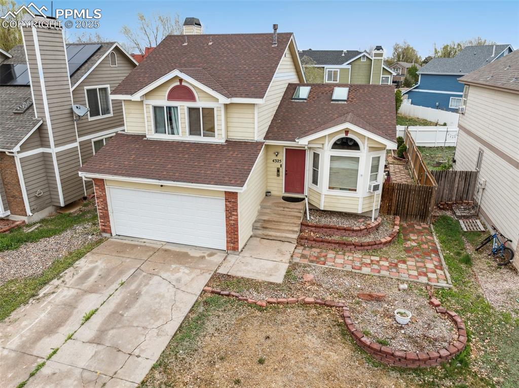 Image 3 of 35: View of front of property with brick siding, driveway, roof with shingles,