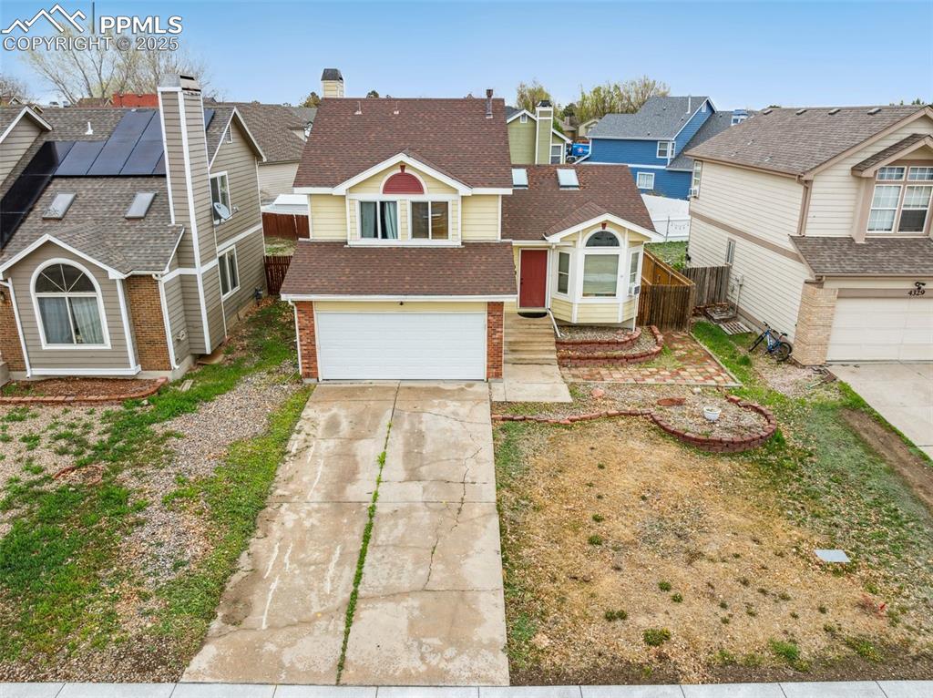 Image 4 of 35: View of front of house featuring a residential view, brick siding, fence, c