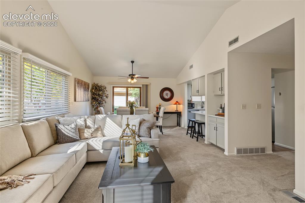 Image 12 of 27: Vaulted ceilings, large windows with blinds, ceiling fan, built-in cabinetr