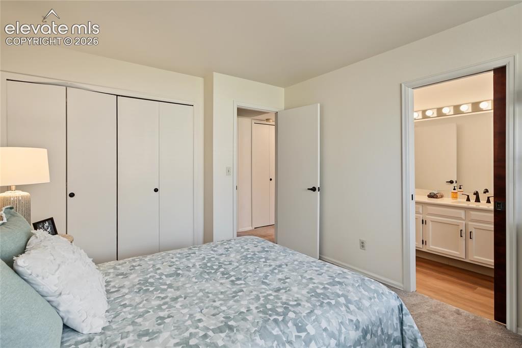 Image 16 of 27: Wall-to-wall carpeting, bi-fold closet doors, and painted walls