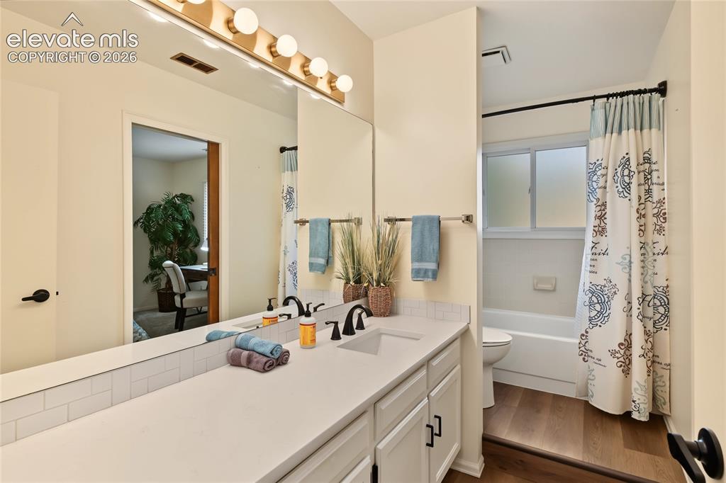 Image 17 of 27: Dual vanity with a single basin, undermount sink, and matte black fixtures