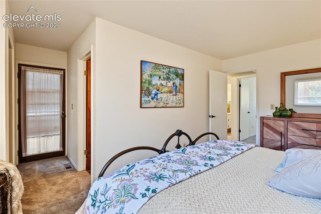 Image 20 of 27: Carpeted flooring complemented by light-colored walls