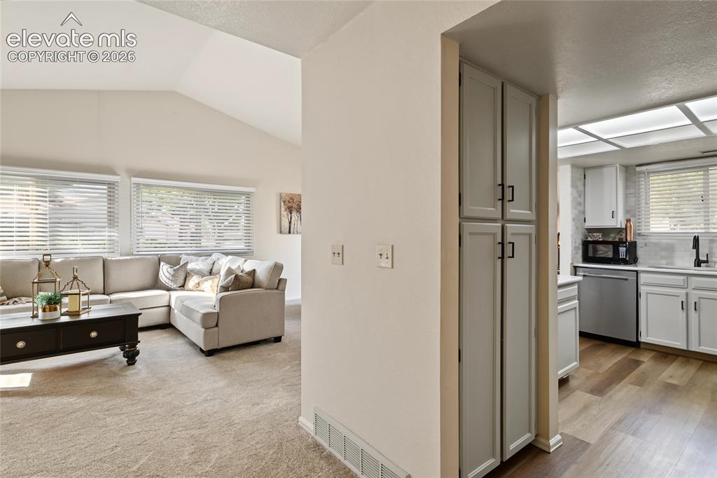 Image 7 of 27: Vaulted ceiling with multiple windows