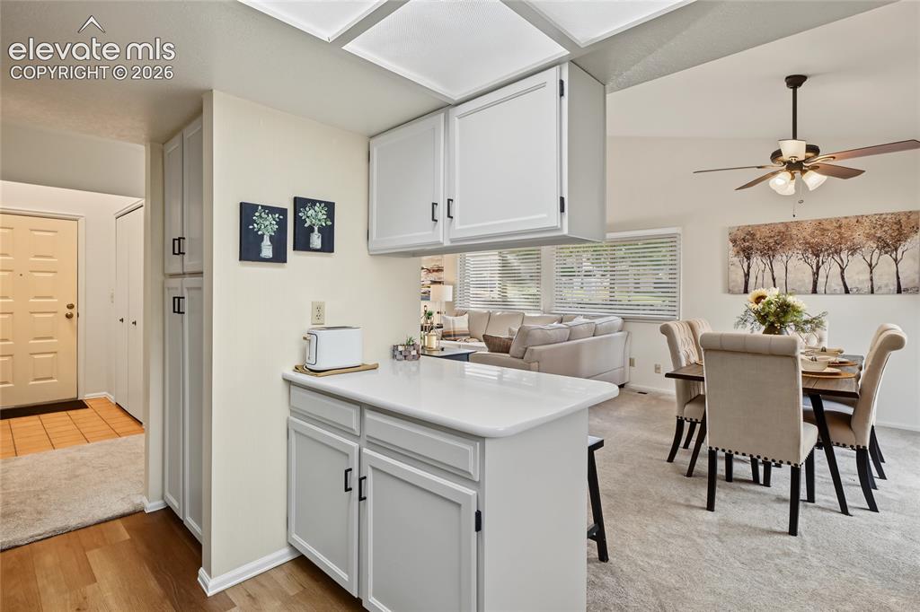 Image 9 of 27: Kitchen featuring white cabinetry and a white countertop