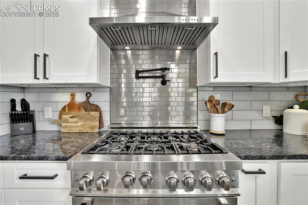 Image 10 of 36: Custom Kitchen with gas range and hood
