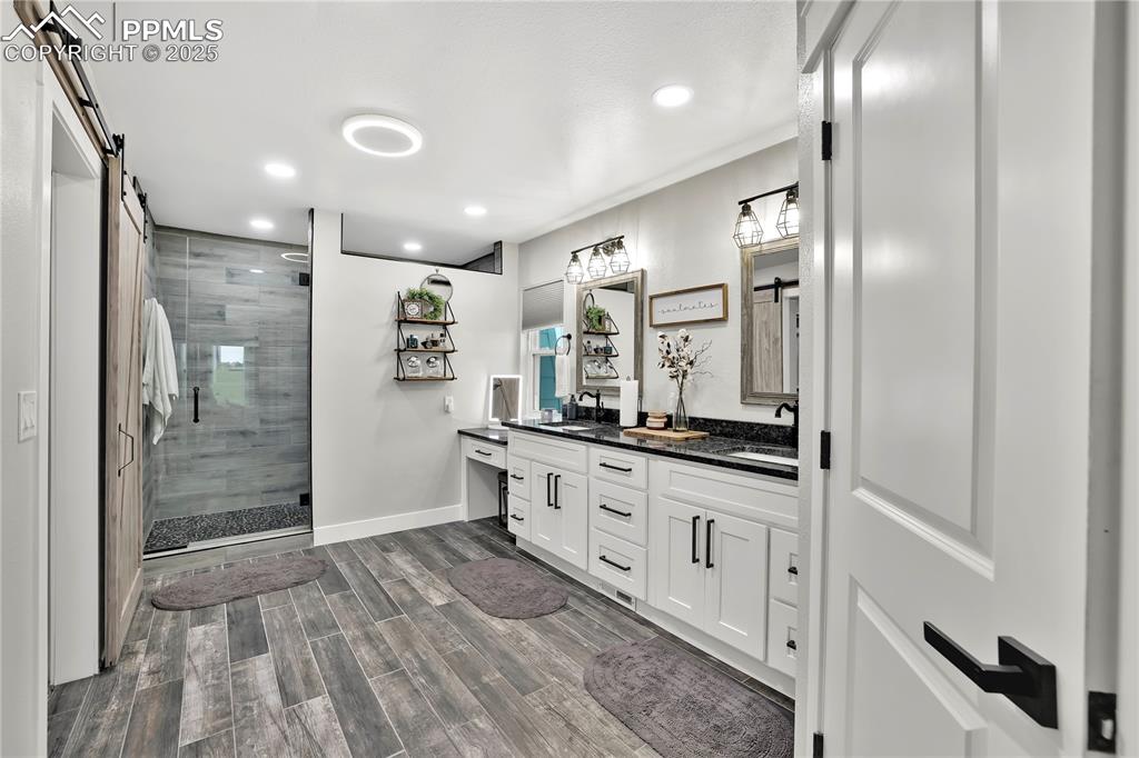 Image 19 of 36: Main Bathroom attached, toilet closet, double sink, vanity area, walk in sh