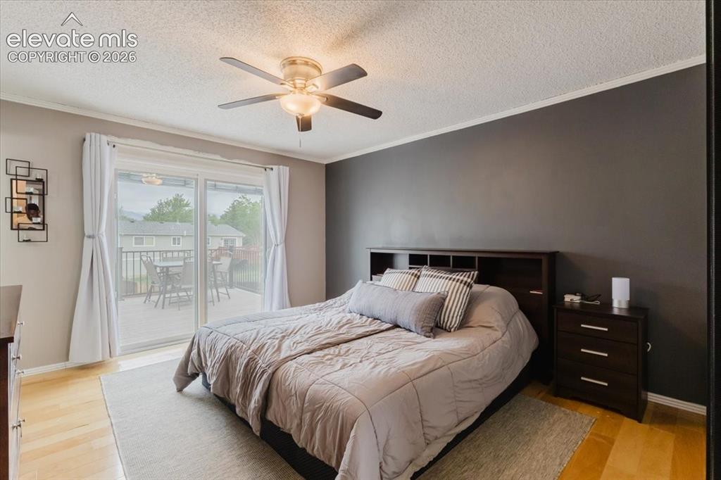 Image 25 of 49: Primary bedroom with walkout to deck