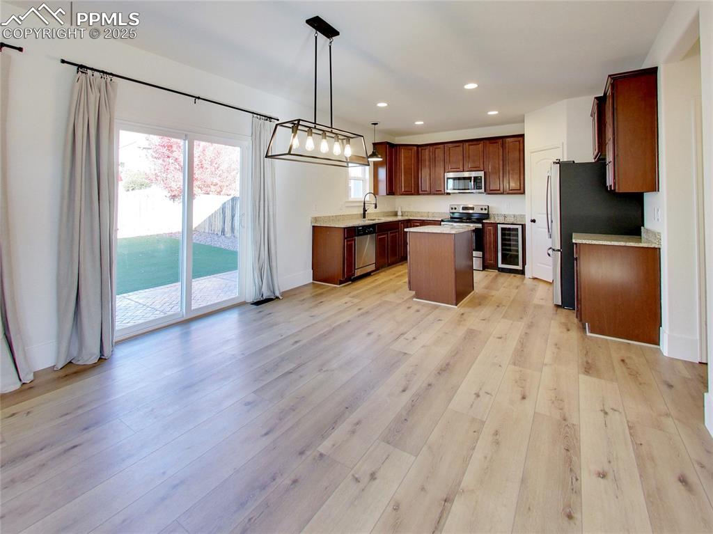 Image 10 of 37: Kitchen featuring hanging light fixtures, recessed lighting, a center islan