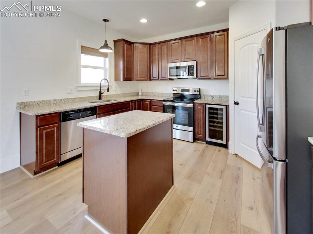 Image 12 of 37: Kitchen featuring appliances with stainless steel finishes, pendant lightin