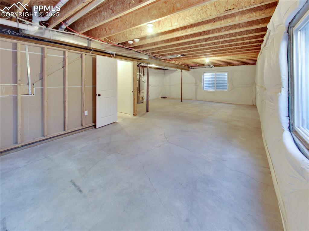 Image 28 of 37: Below grade area featuring gas water heater