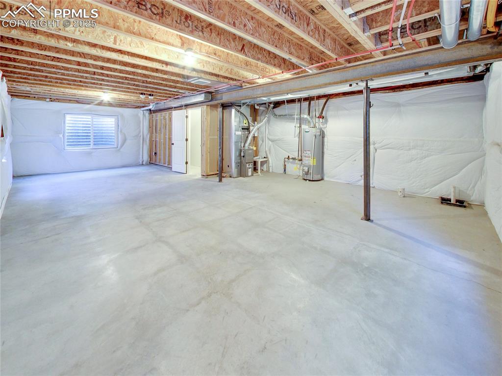 Image 29 of 37: Basement featuring water heater and heating unit