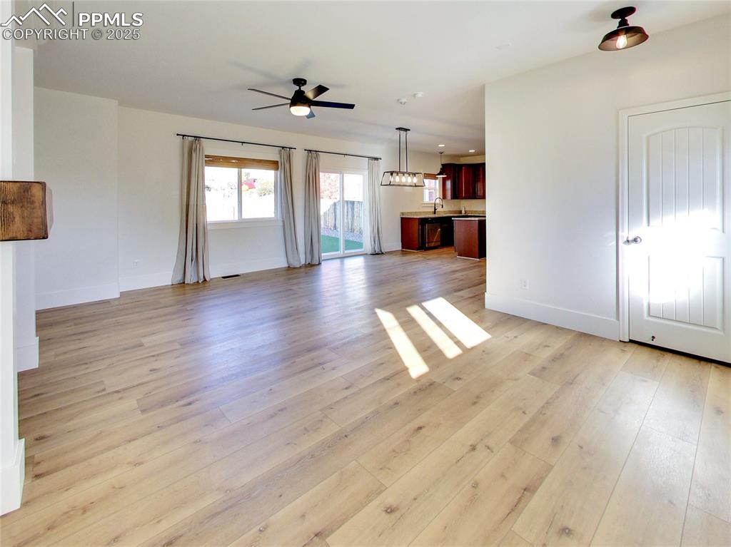 Image 8 of 37: Unfurnished living room with light wood-type flooring, ceiling fan, and rec
