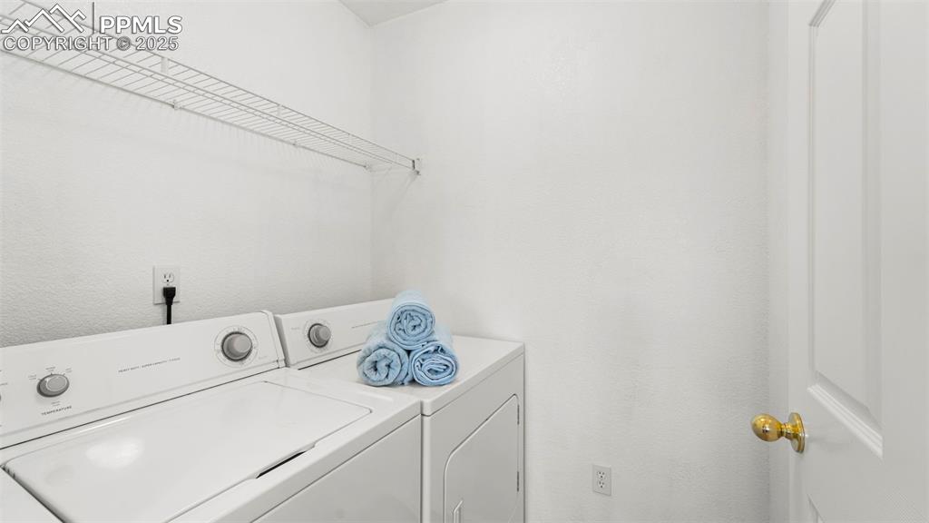 Image 15 of 46: Washroom with separate washer and dryer and a textured wall