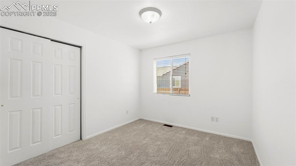Image 17 of 46: Unfurnished bedroom with carpet flooring and a closet