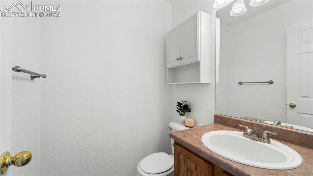 Image 18 of 46: Half bath featuring vanity and toilet