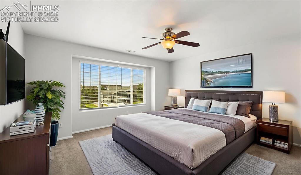 Image 20 of 46: Carpeted bedroom featuring baseboards and a ceiling fan - Virtually Staged