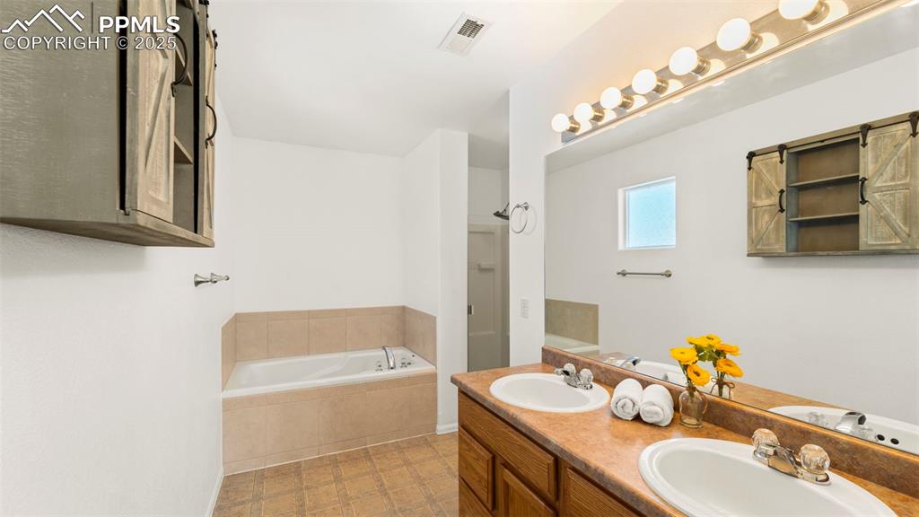 Image 23 of 46: Full bath featuring a garden tub and double vanity