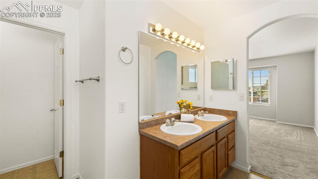 Image 25 of 46: Full bathroom featuring double vanity and baseboards