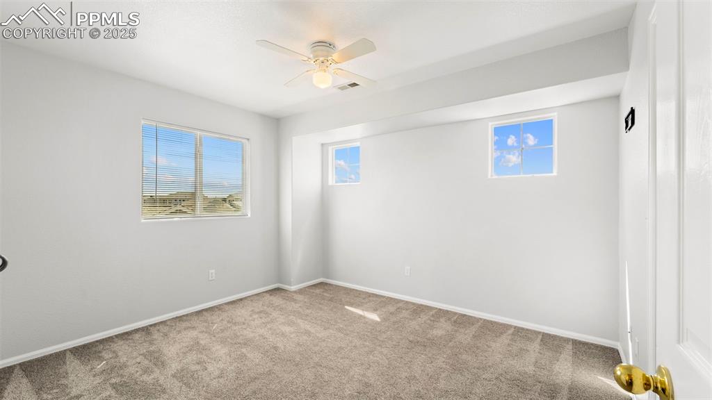 Image 27 of 46: Empty room with carpet and a ceiling fan