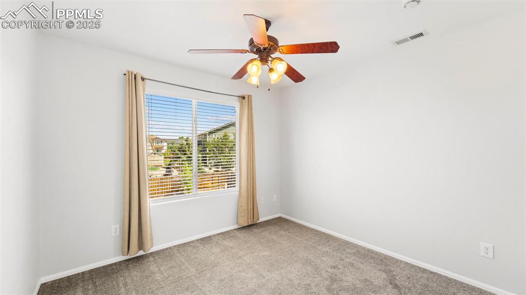 Image 31 of 46: Spare room featuring carpet floors and ceiling fan