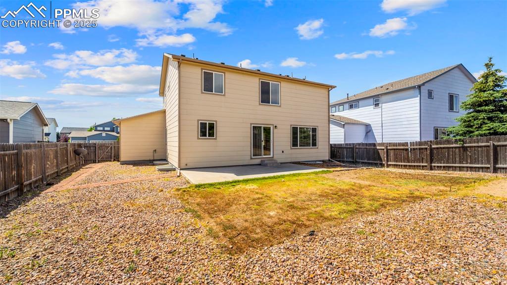 Image 36 of 46: Back of house with a patio area and a fenced backyard