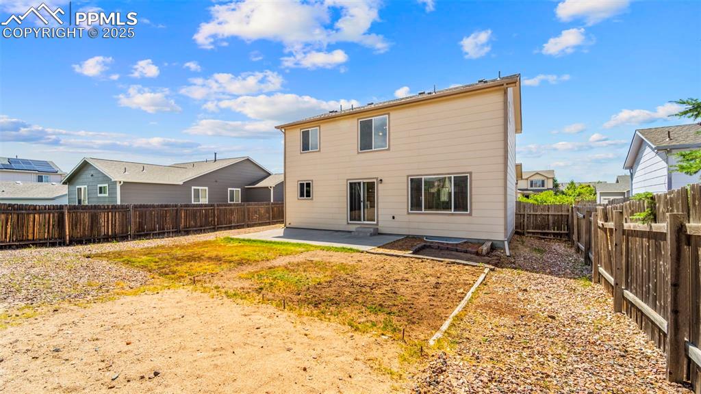Image 37 of 46: Rear view of property with a patio, a fenced backyard, and a residential vi