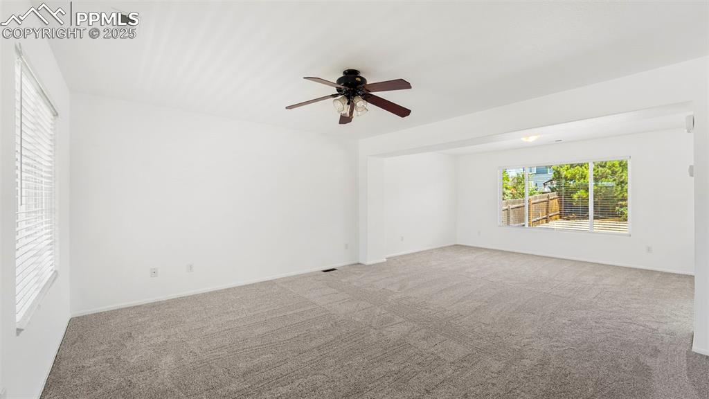Image 5 of 46: Spare room featuring ceiling fan and carpet flooring
